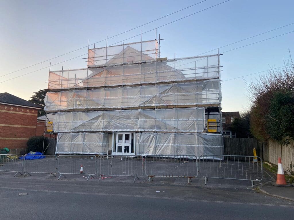 A picture of the Park Centre, a white triangular roofed building covered in scaffolding