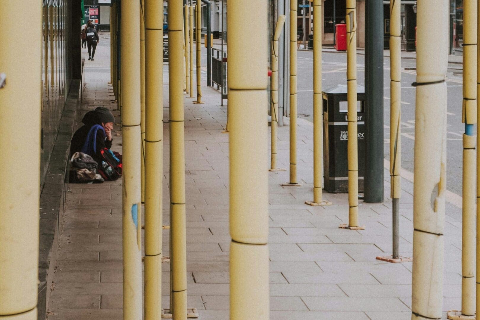 dan-burton-xT8z6nEgQ1U-unsplash A homeless woman sits in the Leeds city centre.