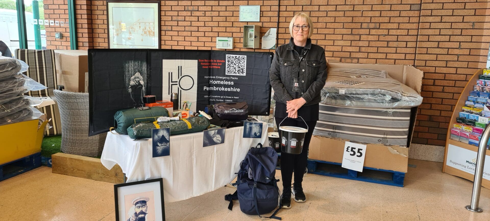 1000001779 Amanda Evans stood before supplies for the homeless