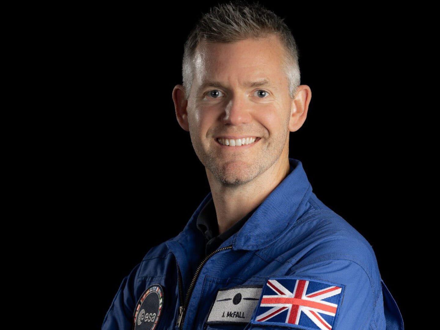 GMV7UVlWIAETNC3 John McFall poses in a blue uniform and a union flag on his arm.