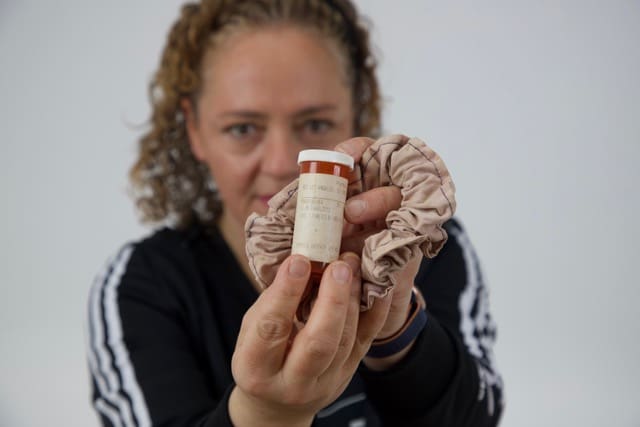 Carlotta Allum holding a pill bottle Carlotta Allum holding a pill bottle