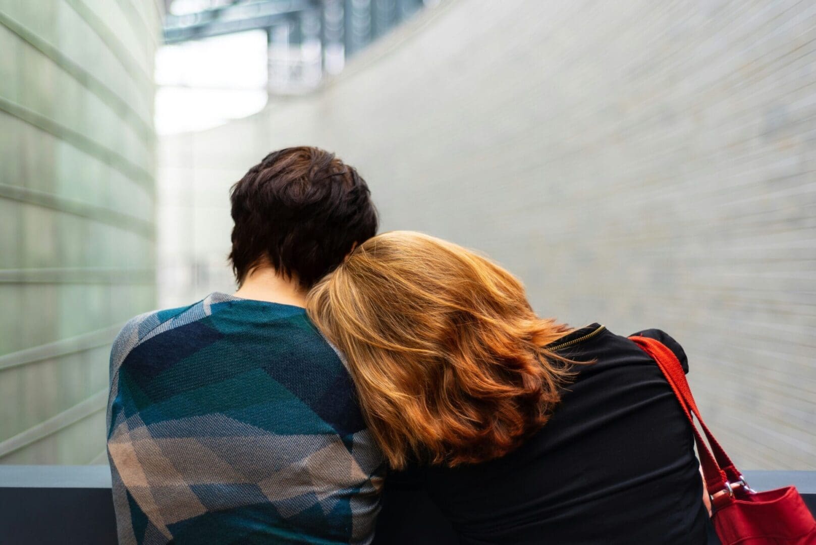 kylli-kittus-KQfxVDHGCUg-unsplash_1_1_optimized_3000 Woman resting her head on a man while they sit on a bench