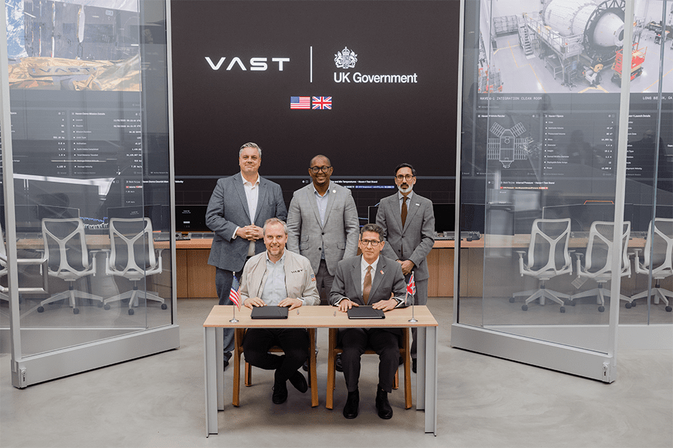 Representatives of the UK government and Vast posing for the photo in suits.